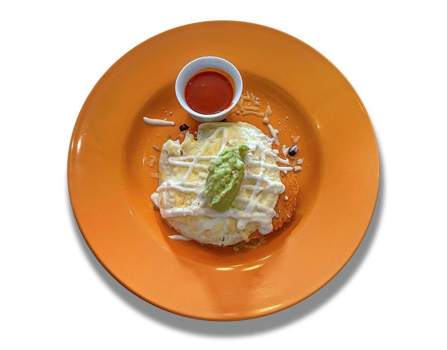 Huevos rancheros on house made corn tortillas with salsa, guacamole and some of the best-cooked rice of all time.