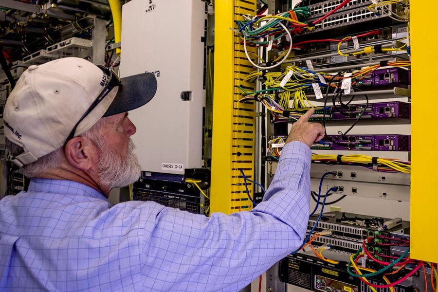 Paul Briesh Jr. checks connections at one of the Baca Valley facilities outside Raton, connecting fiber cables around town to larger data centers in Denver and Albuquerque.