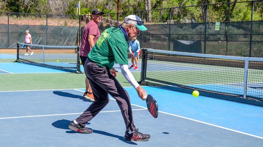 John Cunningham, a member of the Santa Fe Pickleball Club, lobs a ball during open play at Fort Marcy.