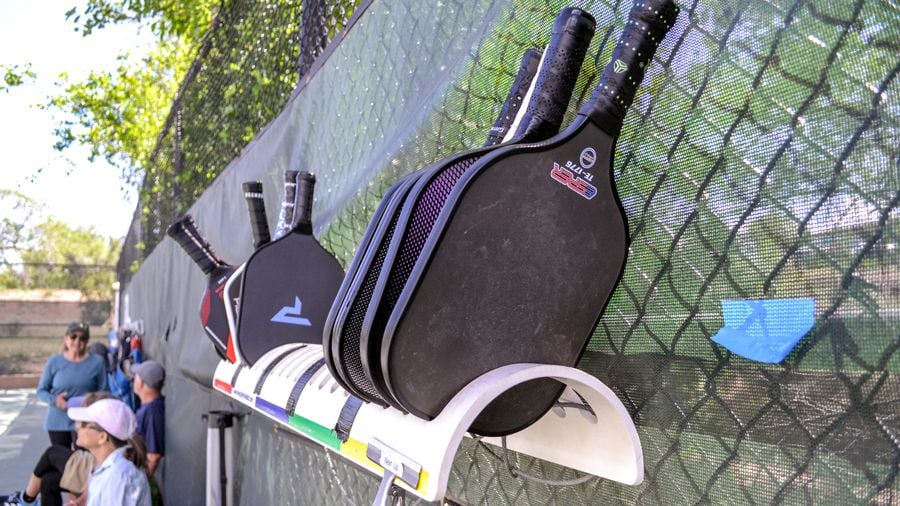 Players at the Fort Marcy courts use their paddles to queue up for the next game.
