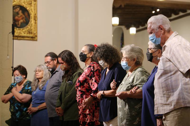 Tularosa Downwinders stand to receive Archbishop John C. Wester's prayer for healing.